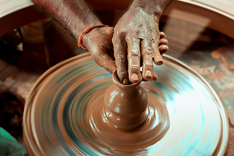 Throwing a pot in clay on the potter's wheel